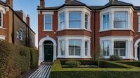 An Edwardian red-brick semi-detached house with clean bay windows